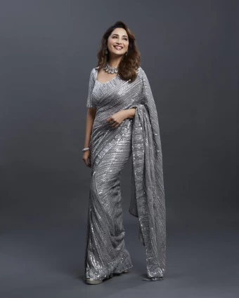 Madhuri Dixit looks chic in the shimmering silver saree