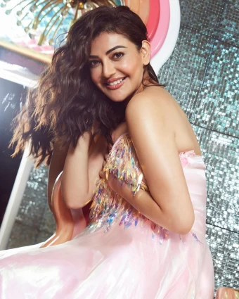 Kajal Aggarwal is looking resplendent in a shiny pink dress.