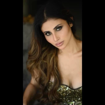 Mouni Roy pairs her outfit with bold make-up and smokey eyes, giving it a lustrous look