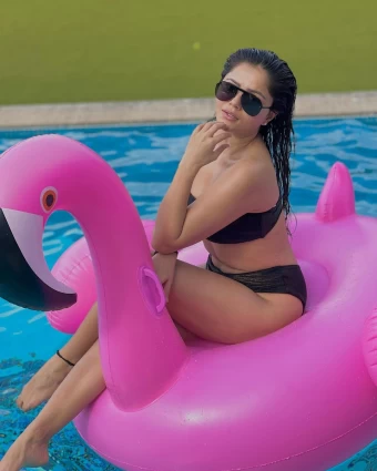 Rubina Dilaik strikes a pose on a floating flamingo in a black two-piece