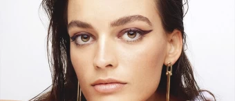 A Closeup Image Of French Actress, Emma Mackey's Makeup Which Features A Bold Winged Eyeliner