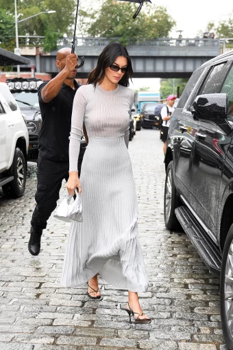 Kendall Jenner arriving at a Fashion Show in New York City. She wore a long gray dress.