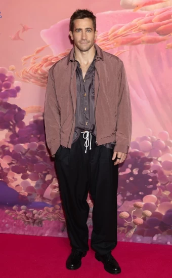 Actor Jake Gyllenhaal keeps it casual in a silk shirt, jacket, black pants, and a rope belt at the Strange World Family Gala Screening in London