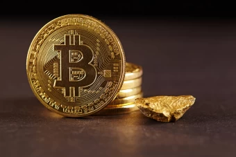 An Incredible Staged Photo Of Gold Bitcoins Next To A Small Gold Rock On A Brown Surface For A Crypto Desktop Background.