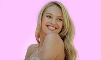 South African Supermodel Candice Swanepoel Smiling Lovingly On A Bright Pink Background
