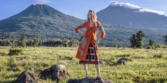 The South Africa Supermodel Candice Swanepoel Wearing A Beautiful Orange And Nature Patterned Prada Wardrobe In Rwanda.