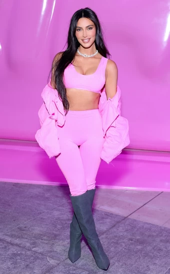 Businesswoman and reality star Kim Kardashian charms in a bright pink two-piece, jacket