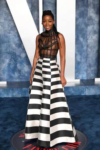 Thuso Mbedu poses in a Dior Haute Couture gown with a caged bodice crafted from black horsehair on the Vanity Fair Oscar Party 2023 red carpet
