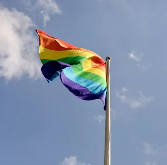 Beautiful image of the LGBT flag with its cute and vibrant colors, captured in a low-angle shot with sky backdrop
