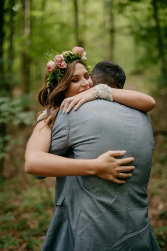 picture of a perfect hug by a newlywed couple in the woods