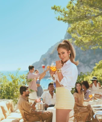 Lopez sipped a fruity drink in a promotional photo for Delola