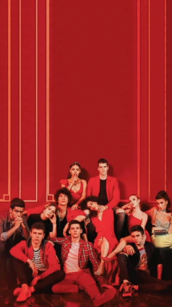 An intimidating poster of the Elite Netflix series cast as everyone is nicely dressed in red against a crimson wall.