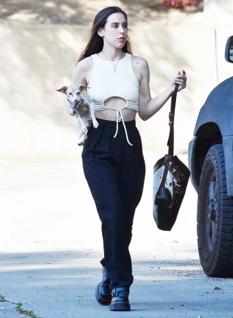 Scout Willis takes a stroll with her dog in Los Angeles. She rocked black pants and a tie-front crop top for the outing