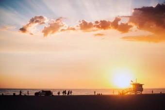 sunset from a crowded beach at the venice beach bo