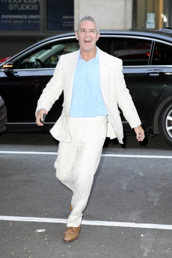 Andy Cohen is elated upon arriving at 
