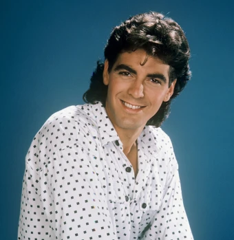 George Clooney in a promo photo for ‘The Facts Of Life.’ He wore a patterned shirt and a mullet.