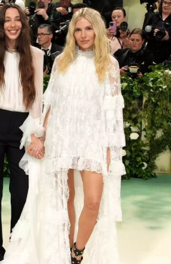 Sienna Miller wears tiered white lace with studded heels.