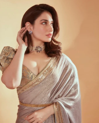 Pair your saree with a deep-neck blouse that highlights the cleavage in a graceful way. Tamannaah pairs a silk saree with this cleavage-baring blouse with puffed sleeves.
