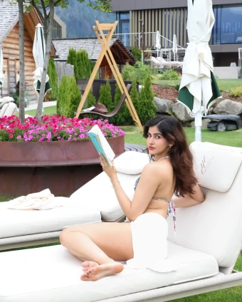 Turning a garden lounge into her runway, Sakshi blends leisure, a book, and bold summer sass–who says brains and bikinis can’t mix?