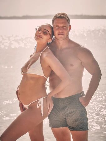 Olivia Culpo shows off her baby bump in a bikini while celebrating Christian McCaffrey’s 30th birthday.