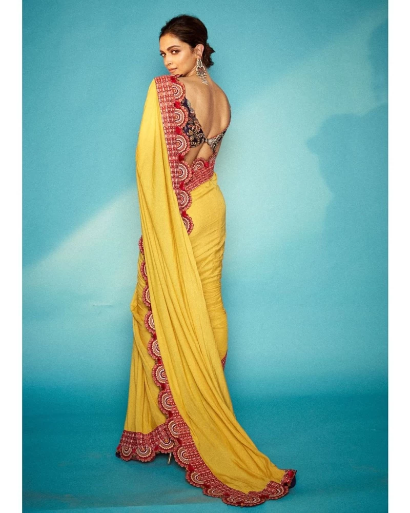 Deepika Padukone casts a spell draped in the yellow saree with a scalloped border.