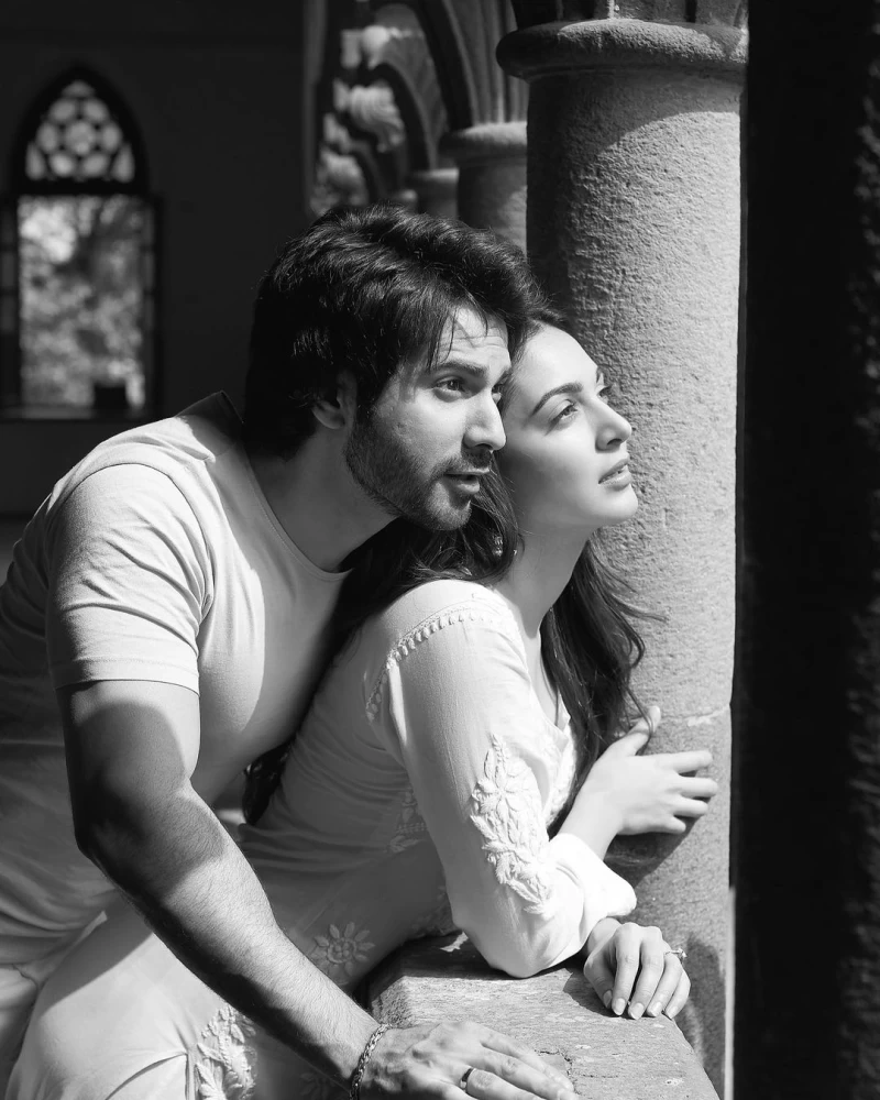 Varun Dhawan and Kiara Advani are peeping out of a balcony in an aesthetic black and white picture