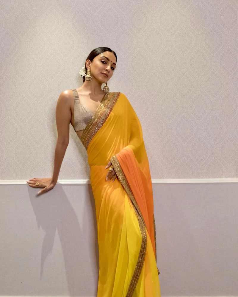 Kiara Advani looks gorgeous in the vibrant saree with a silver blouse, jhumkas and flowers