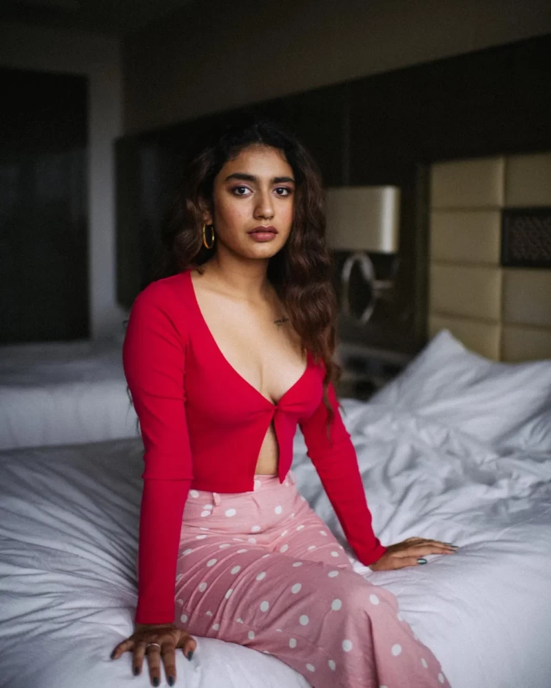 Priya Prakash Varrier drops some smoldering pictures from her latest photoshoot with a red top and pink polka dot trousers.