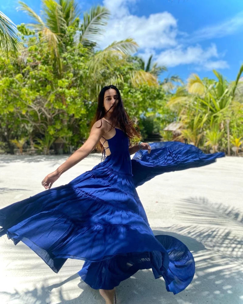 Surbhi Jyoti twirls in a blue dress while posing on the beach