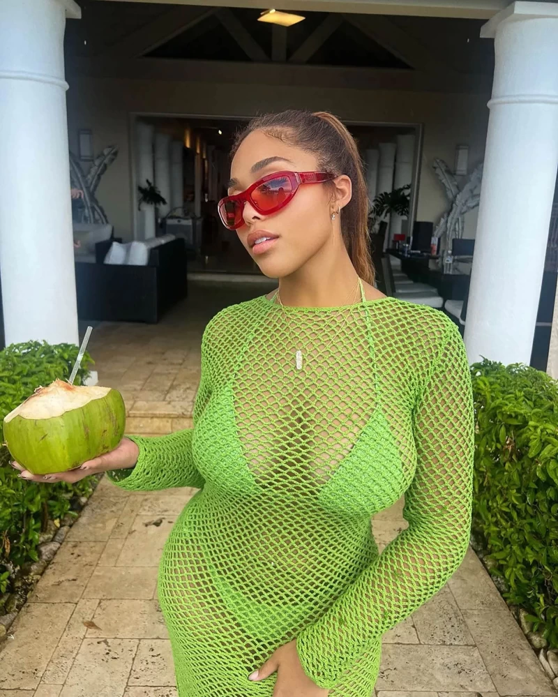 Jordyn Woods is a vision in green to complement her coconut drink