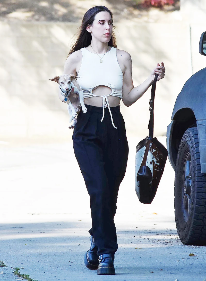Scout Willis takes a stroll with her dog in Los Angeles. She rocked black pants and a tie-front crop top for the outing