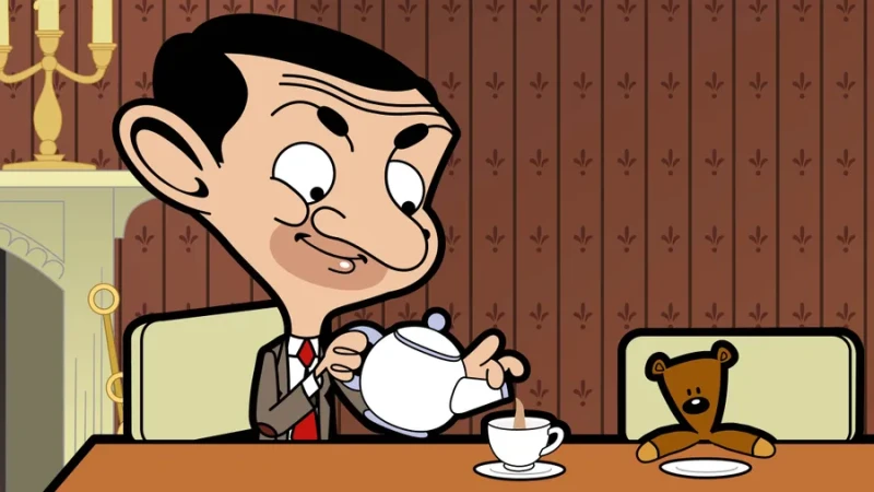 A Mr. Bean 4K wallpaper of a cartoon Mr. Bean pouring a cup of tea from a teapot for himself. His brown teddy bear is seated next to him in front of a saucer on the table.