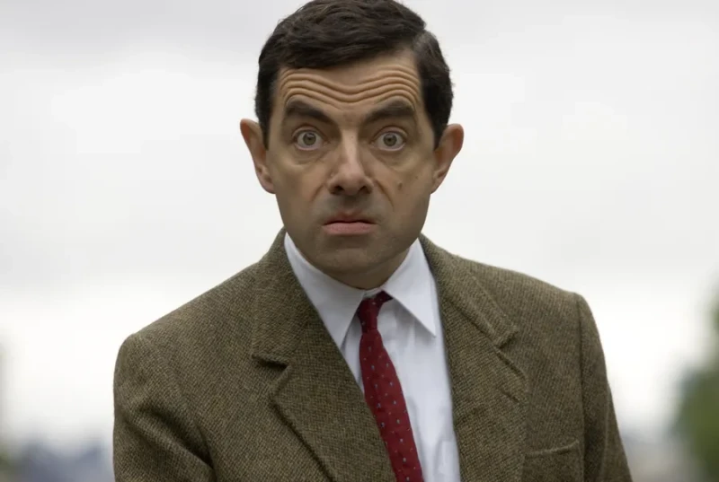 A Mr. Bean 4K wallpaper of Mr. Bean staring intensely with wide eyes at the camera.