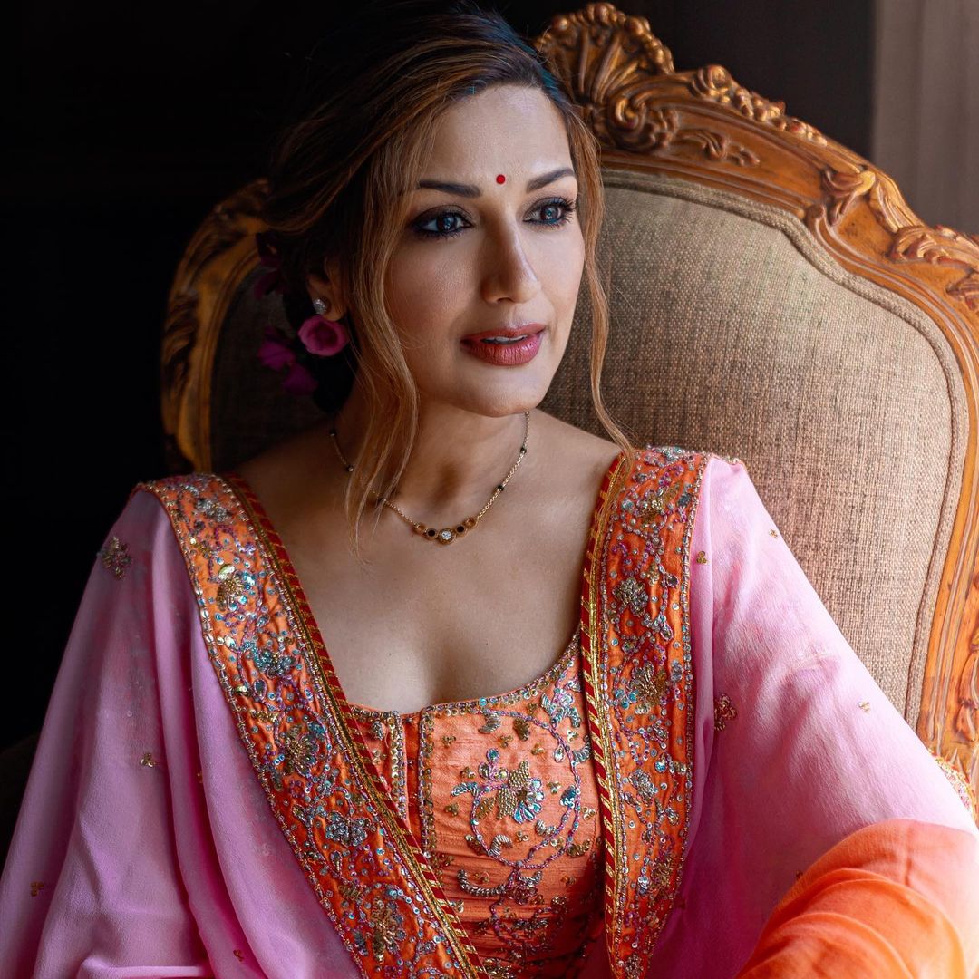 Sonali Bendre looked graceful in an orange and pink lehenga, which was incidentally her wedding lehenga