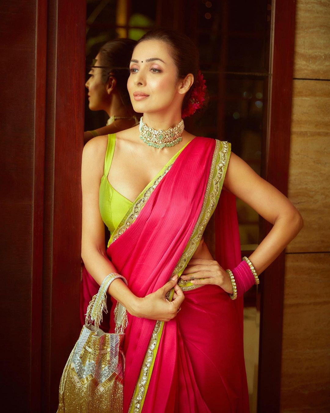 Malaika Arora flaunts her cleavage in the parrot green sleeveless blouse with a low neckline