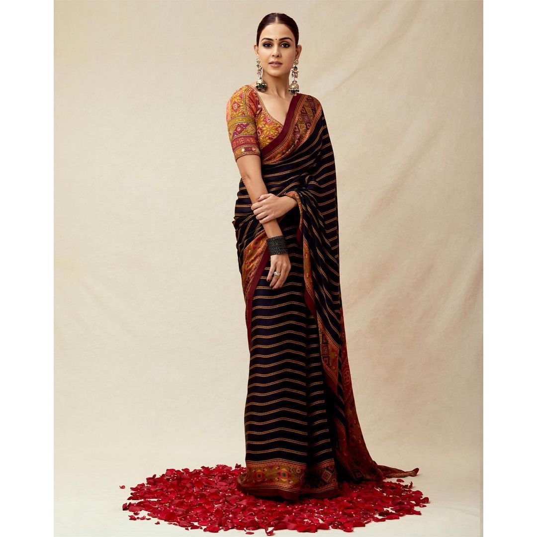 Genelia D'Souza's six yards of elegance comes in a jet black shade adorned with rusty orange stripes all over