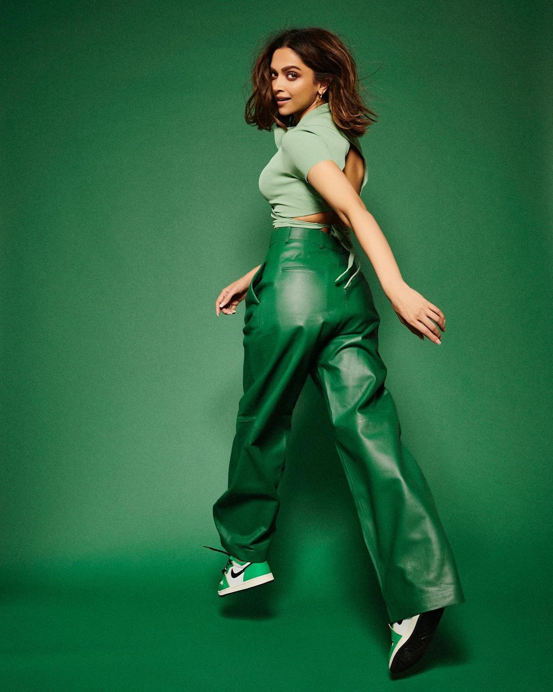 Deepika Padukone aces the smart casual look in the green faux leather pants and complimenting top