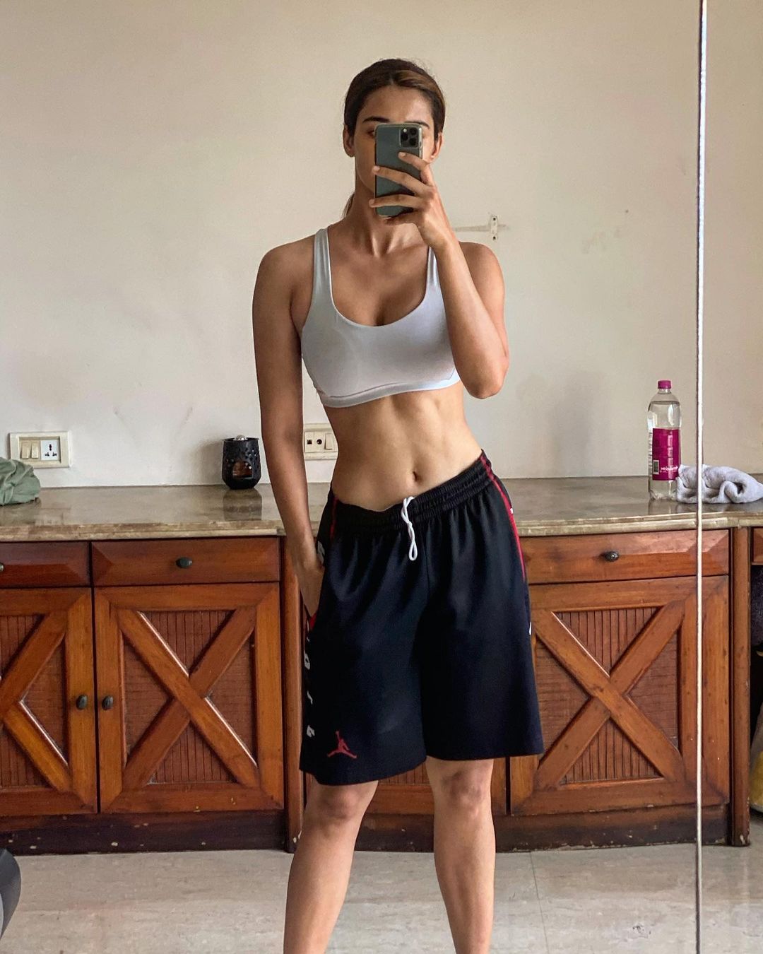 Disha Patani looks flawless in the sports bra and loose shorts while taking another mirror selfie