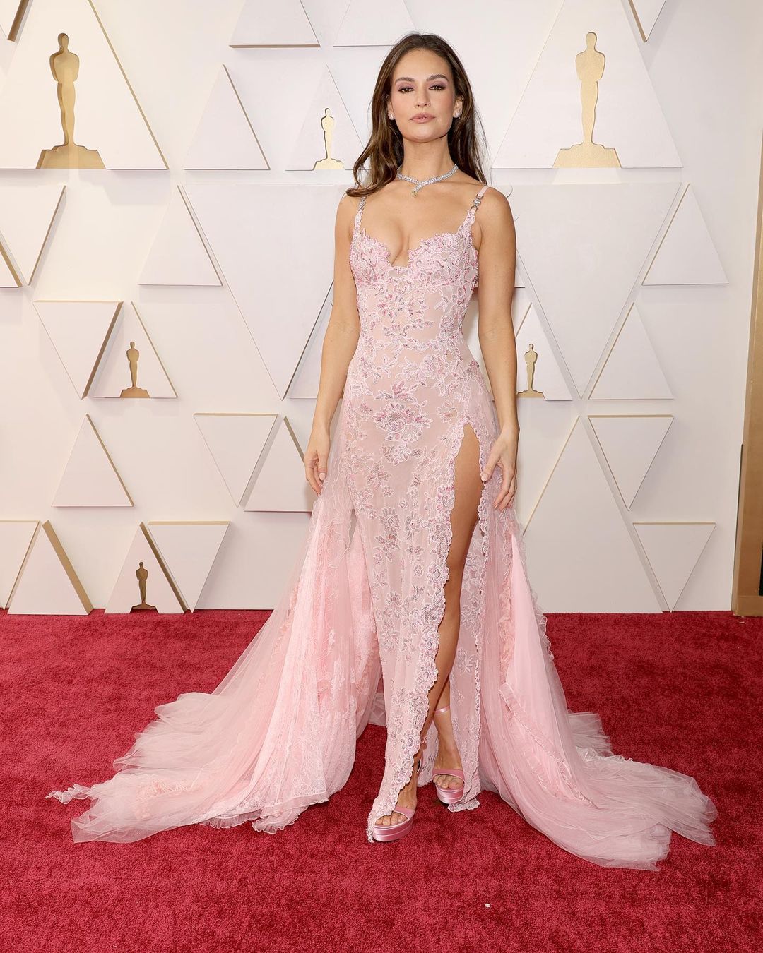 Lily James looks beautiful in the pastel pink Atelier Versace dress