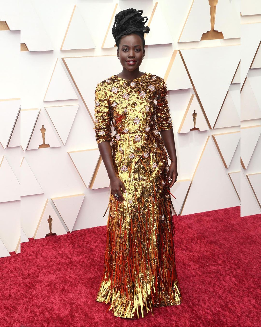 Lupita Nyong'o sparkles in a golden Prada dress