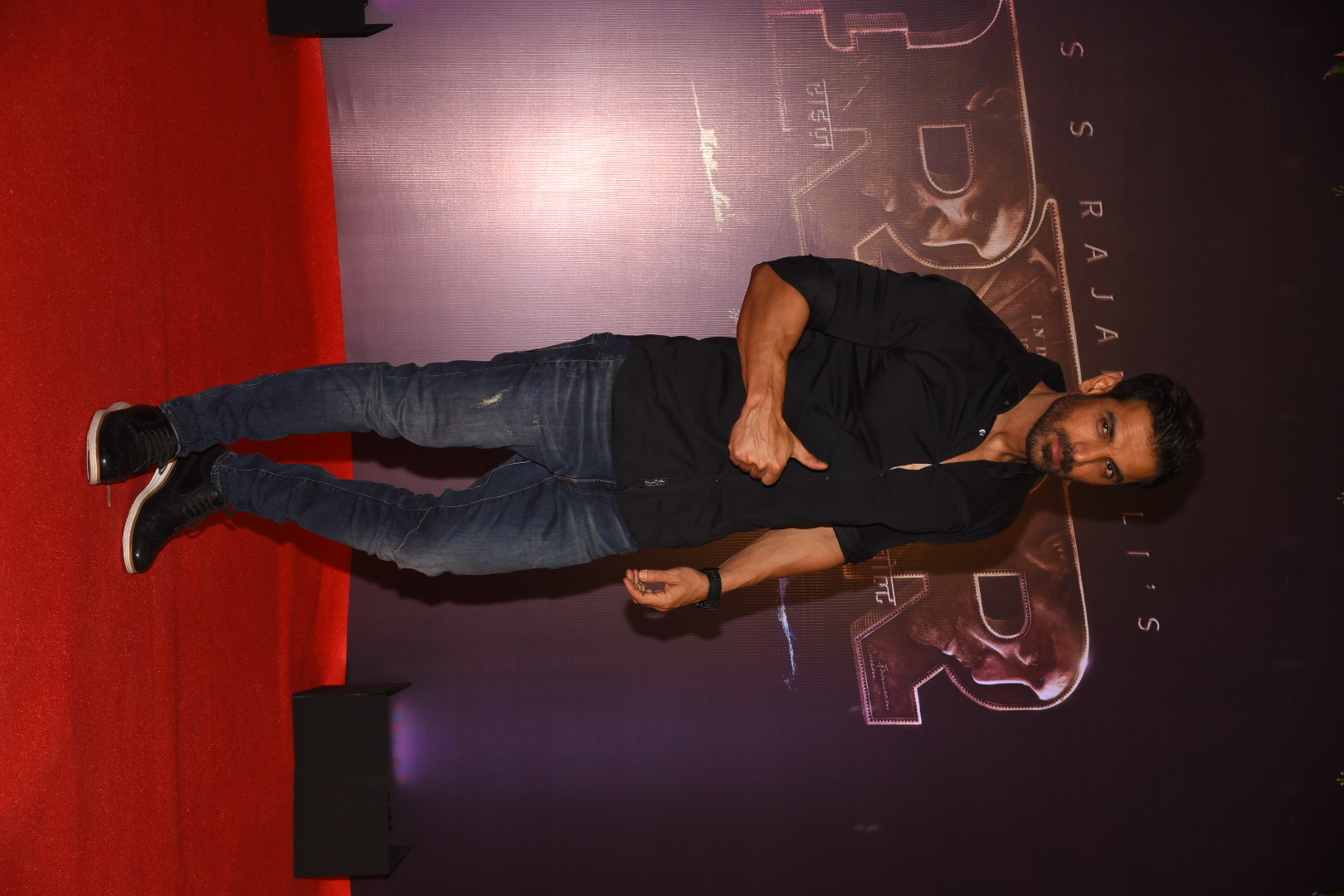 John Abraham gestures to the media
