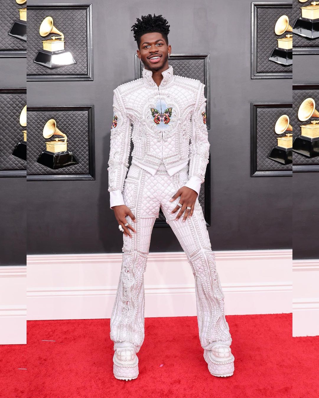 Lil Nas X struck a pose in the embellished white suit by Balmain