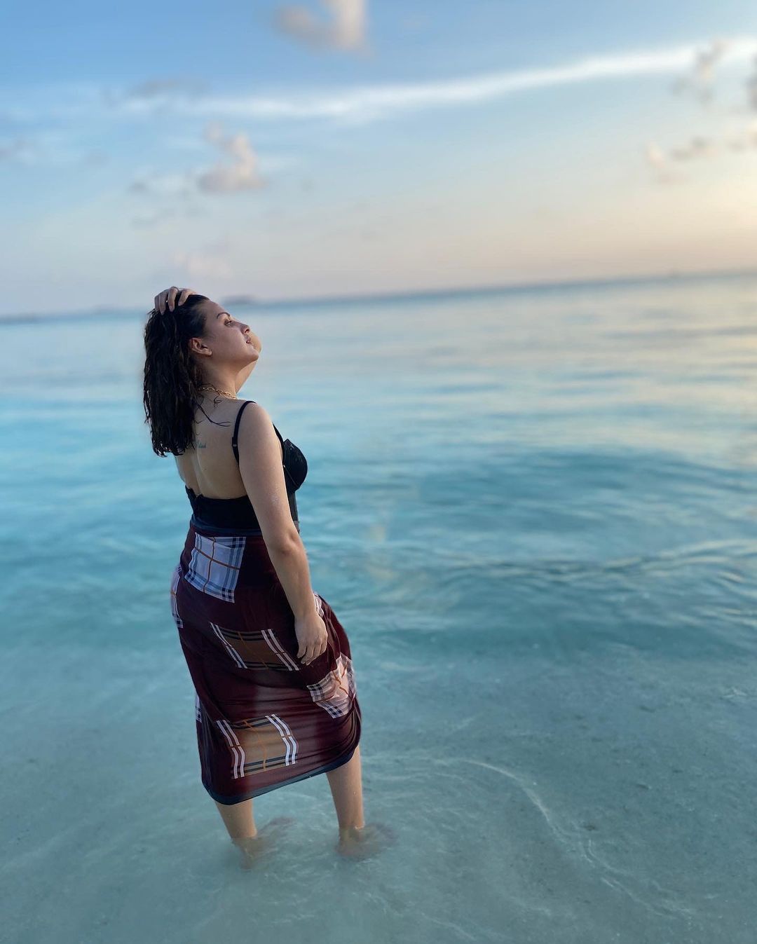 Himanshi Khurana is a breathtaking sight as she stands in the ocean