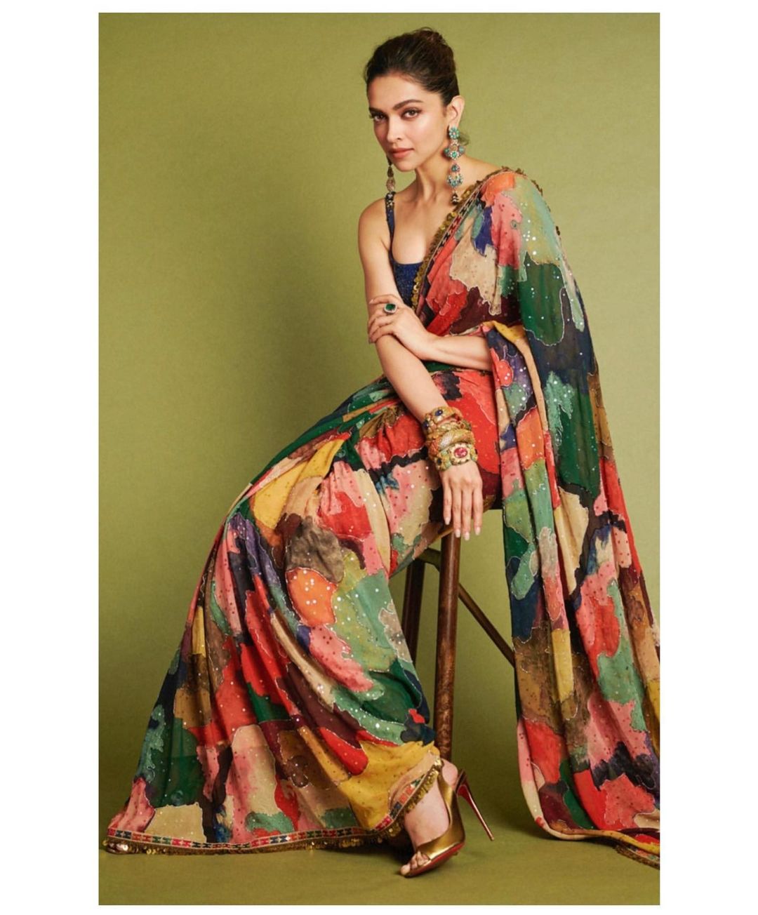 Deepika Padukone sits pretty in the multicoloured shimmer saree