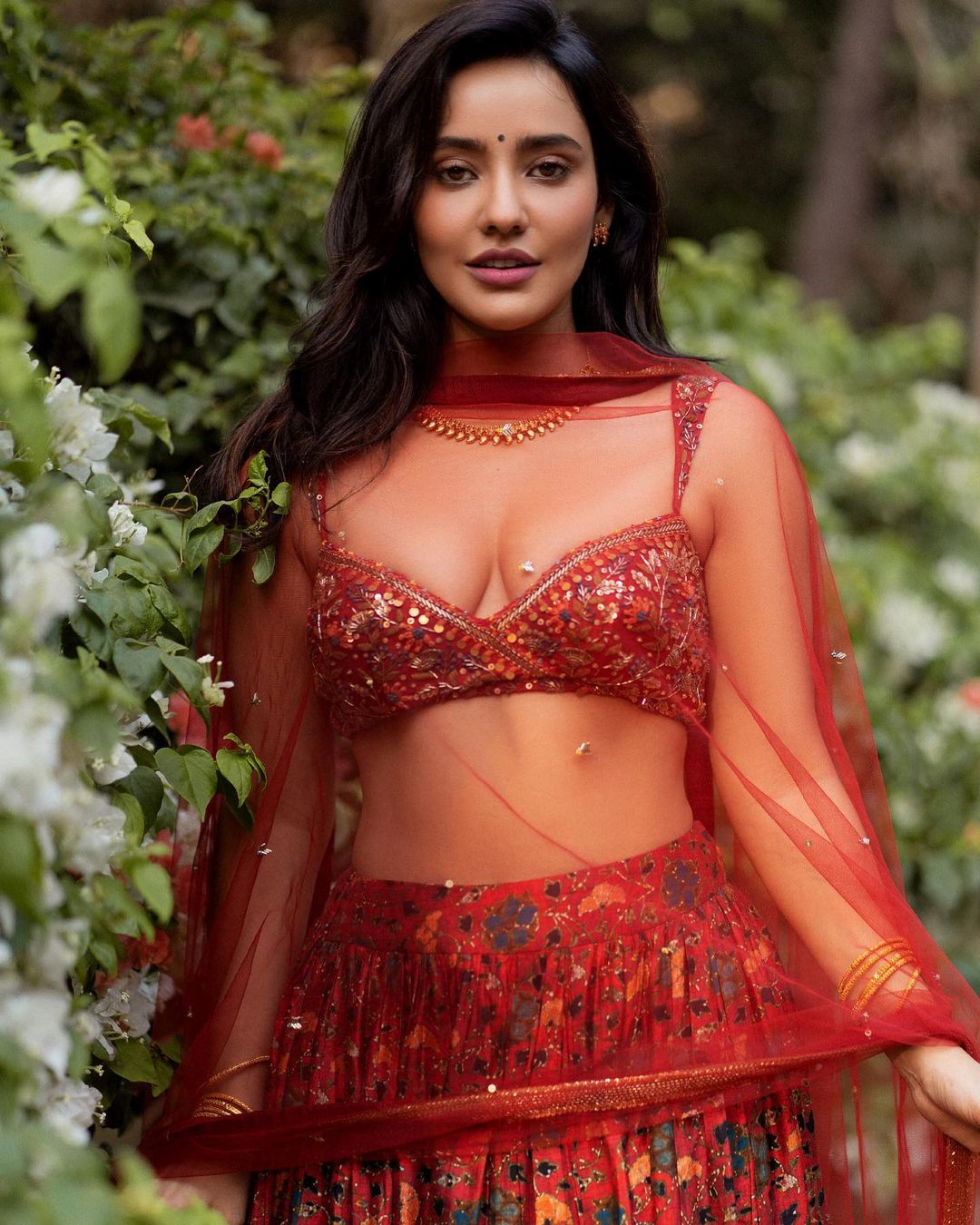 Neha Sharma is raising temperatures in a bold blouse, lehenga and sheer dupatta