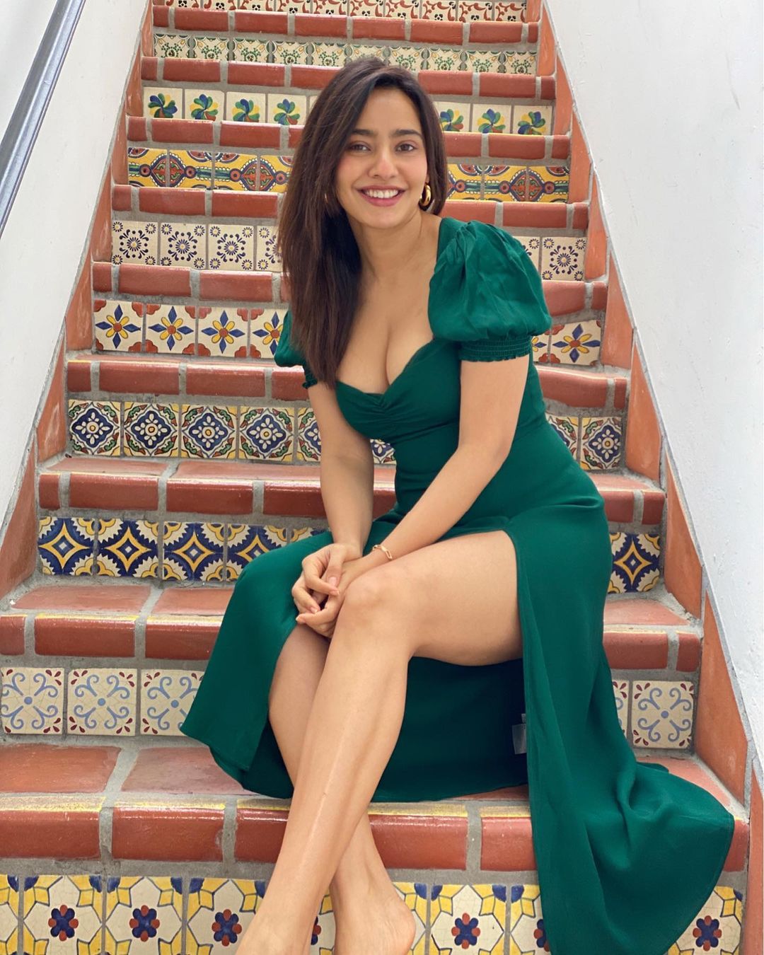 Neha Sharma looks sensational in the green dress with the plunging neckline and high slit