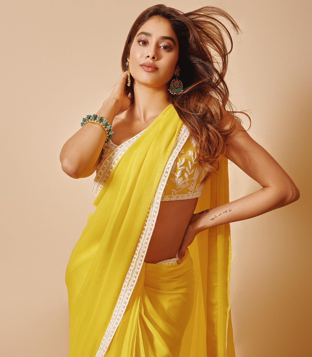 Janhvi Kapoor's plain yellow with the embroidered saree is festival-ready.