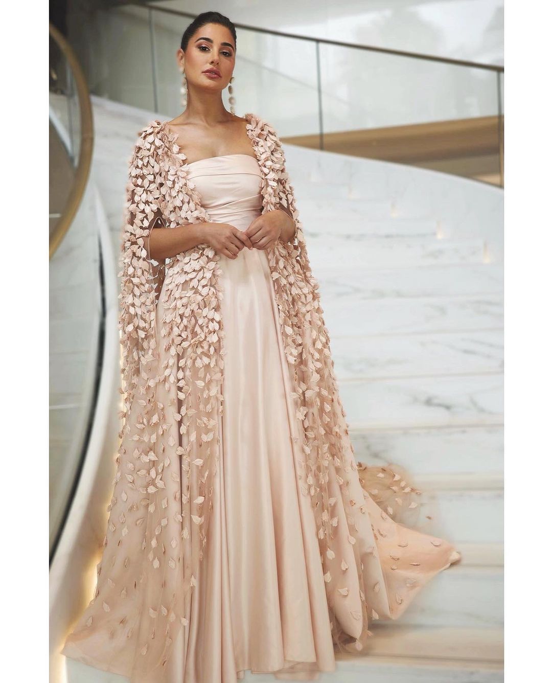Nargis Fakhri cut a statusque figure in the blush pink gown with a cape