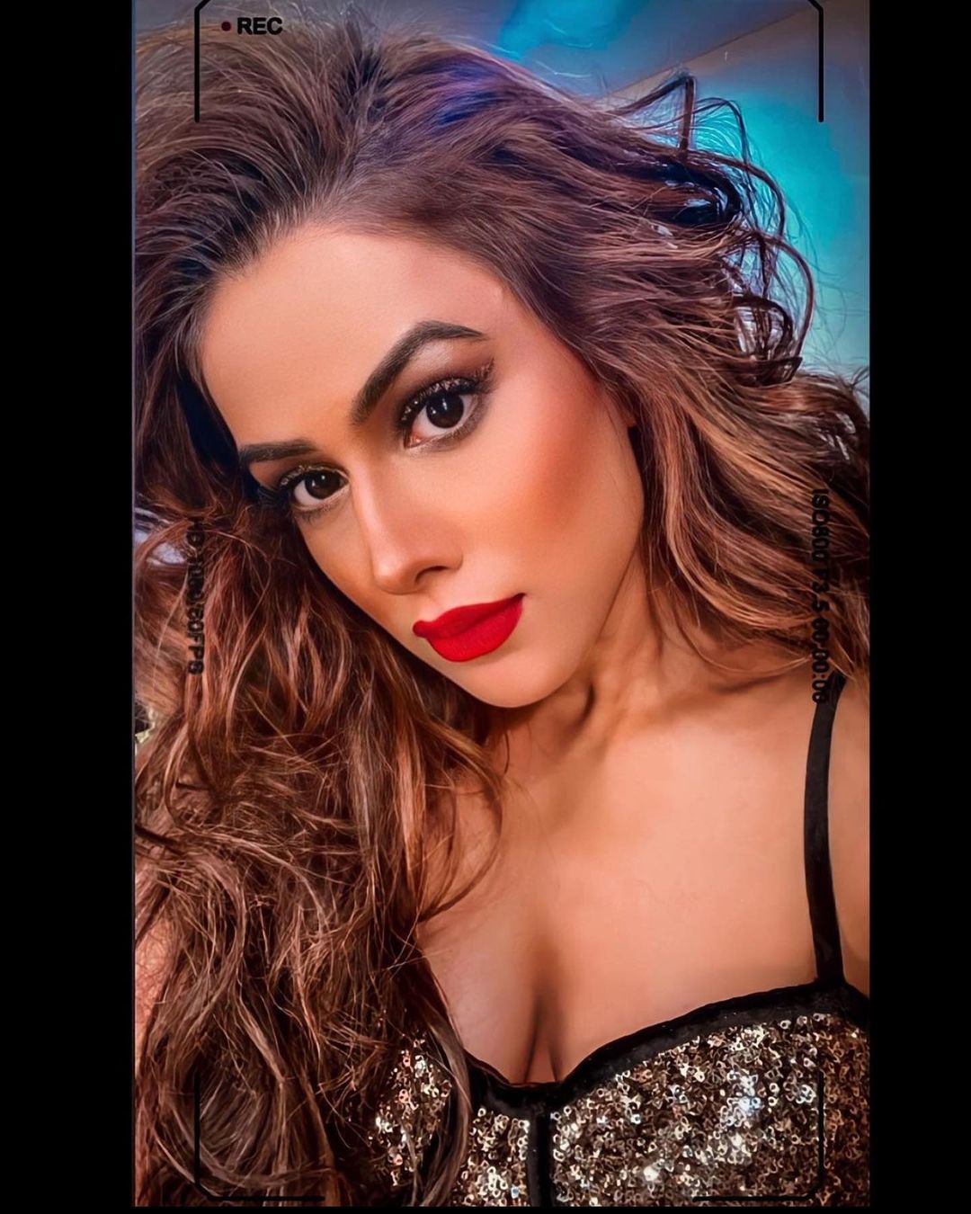 Nia Sharma looks fabulous in the cleavage-baring dress and bold red lips