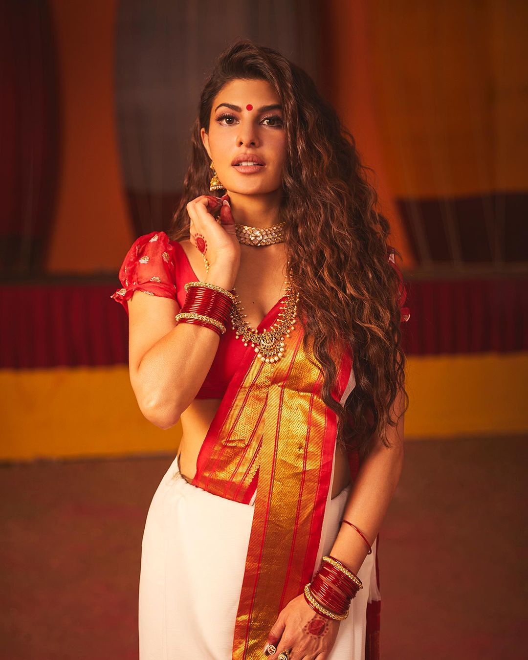 Jacqueline Fernandez looks beautiful in the white and red silk saree